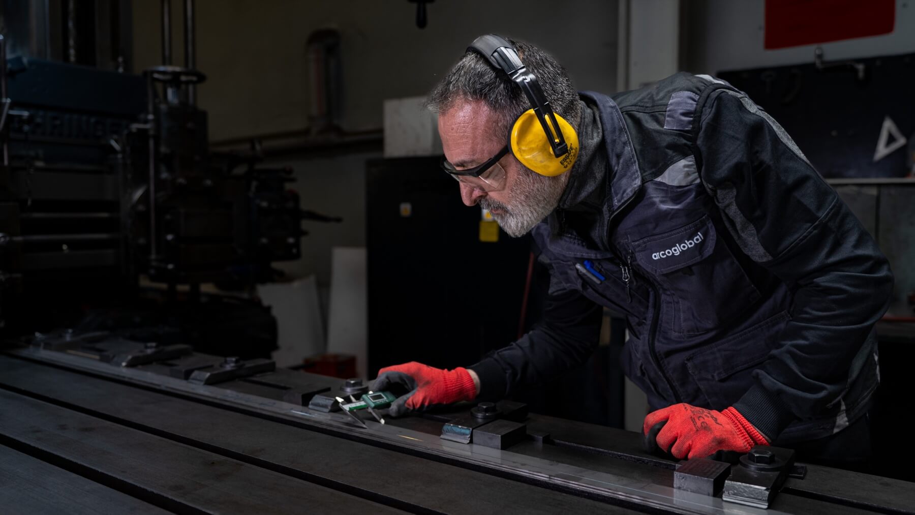 An arcoglobal craftsperson inspecting a metal component
